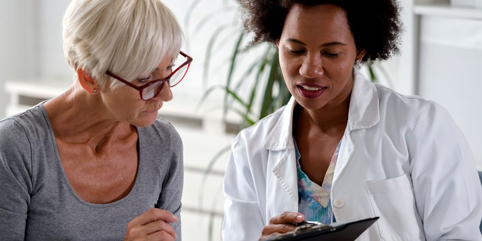 A patient speaks with a doctor.